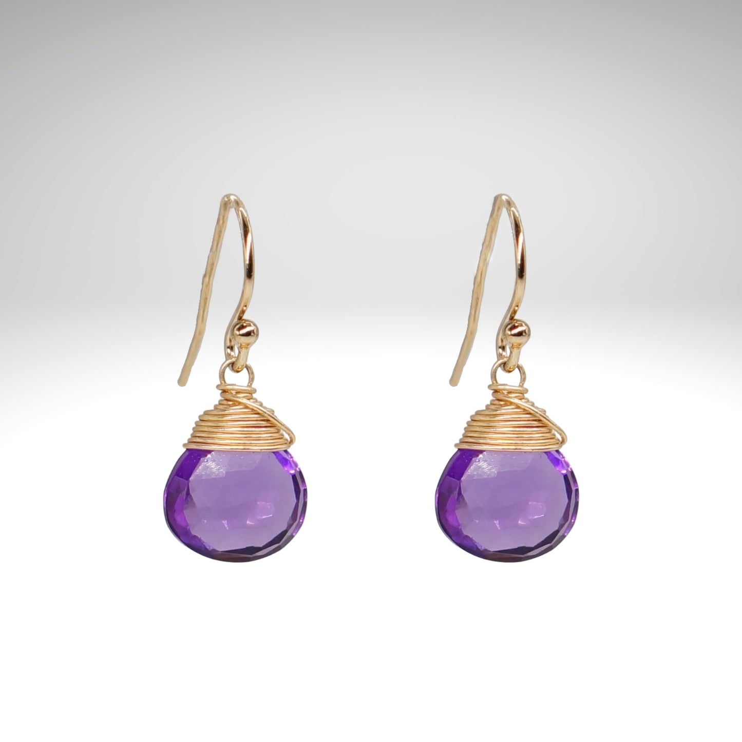 Natural amethyst gemstone earring. Simple teardrop style, wire-wrapped gemstone.
