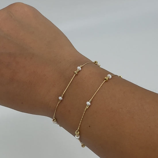 A dainty take on a pearl bracelet. Gold beads float freely in between dainty pearls.   1" extender 14k gold fill  made in Los Angeles  pearls vary in shape and size