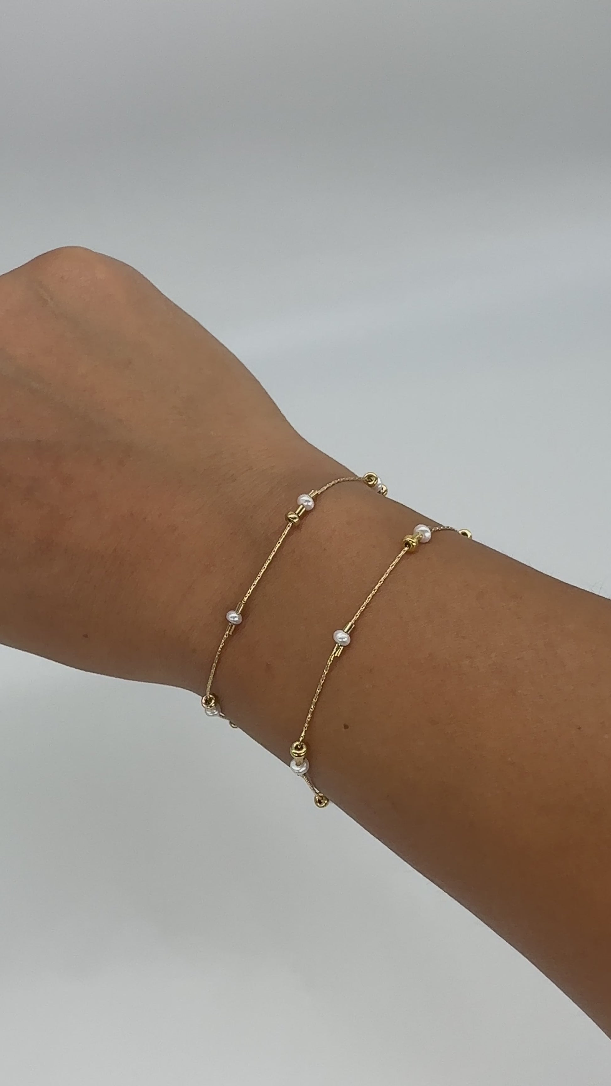 A dainty take on a pearl bracelet. Gold beads float freely in between dainty pearls.   1" extender 14k gold fill  made in Los Angeles  pearls vary in shape and size