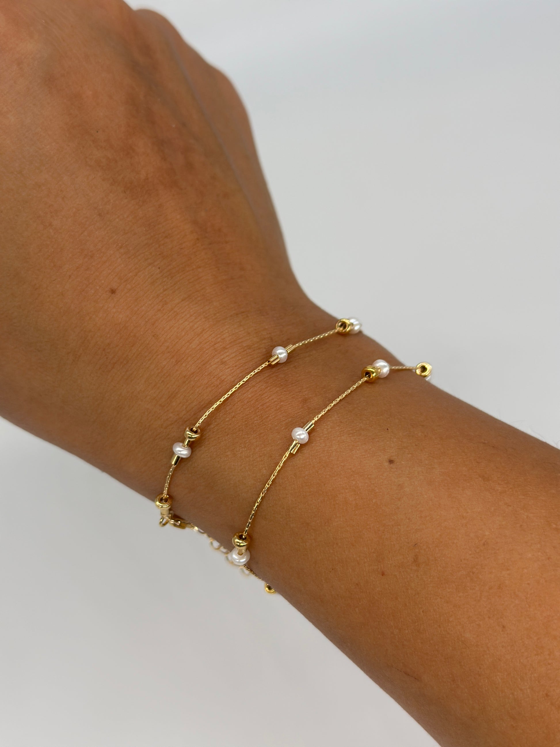 A dainty take on a pearl bracelet. Gold beads float freely in between dainty pearls.   1" extender 14k gold fill  made in Los Angeles  pearls vary in shape and size